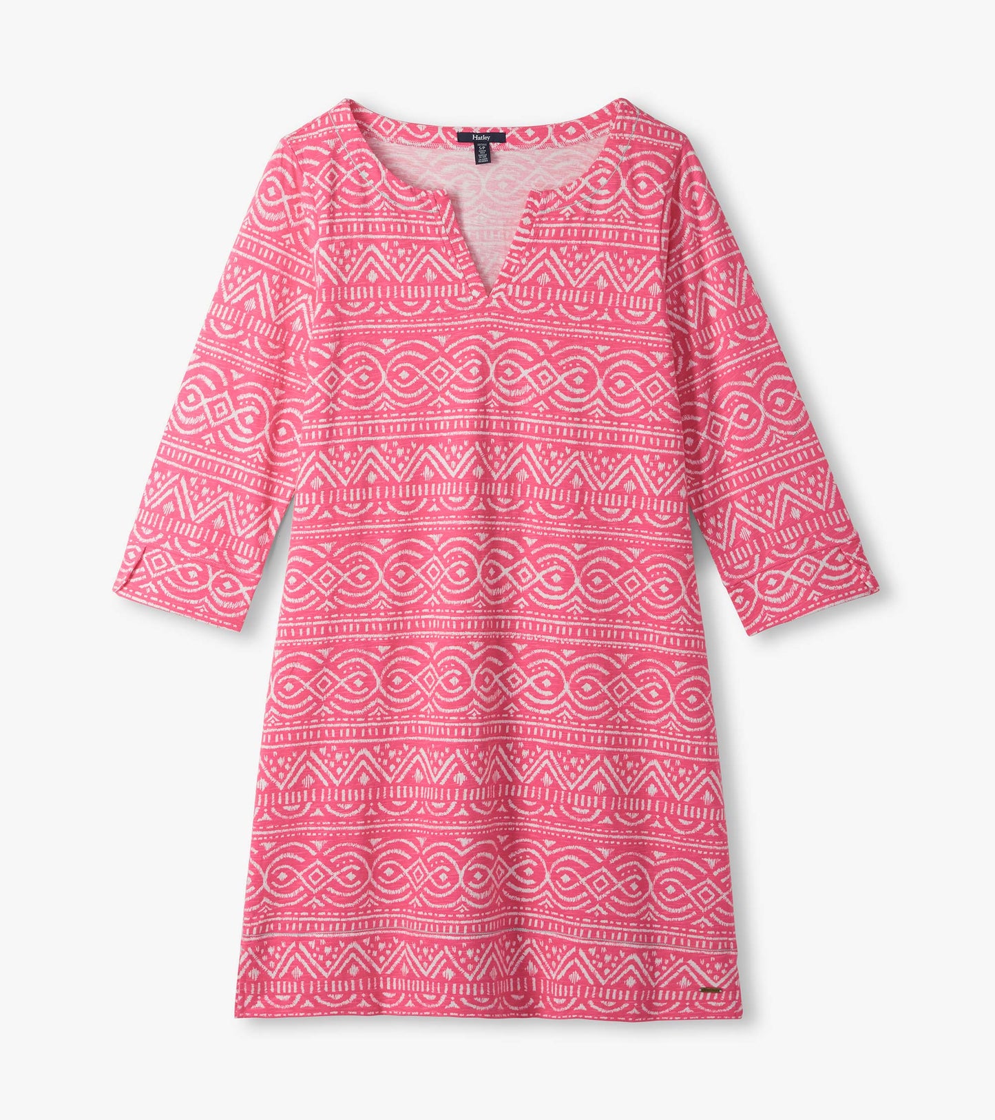 Pink notch neck dress laid flat with white geometric line pattern and three-quarter sleeves