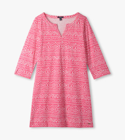 Pink notch neck dress laid flat with white geometric line pattern and three-quarter sleeves