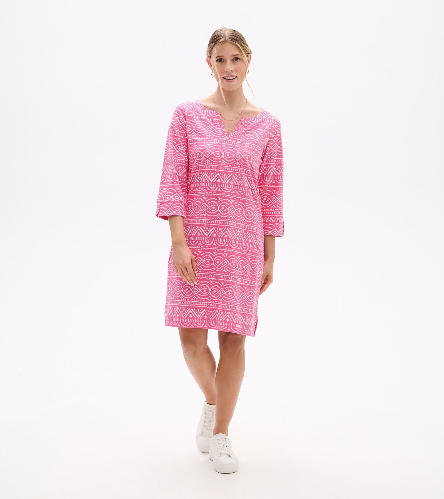 Front full-length view of pink printed notch neck dress with three-quarter sleeves and side hem slit