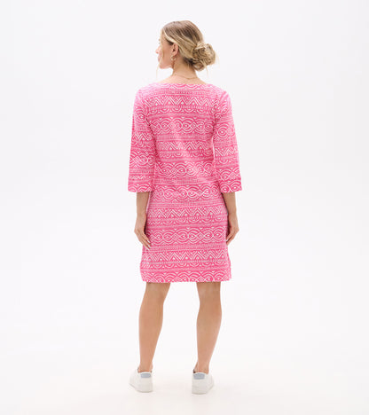 Back view of pink knee-length dress with white geometric line pattern and three-quarter sleeves