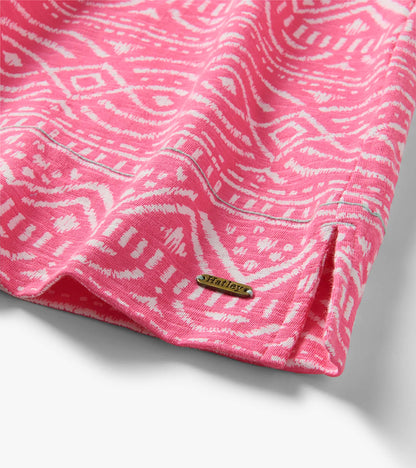Close-up of pink and white sketched line pattern dress hem with visible Hatley metal logo tag