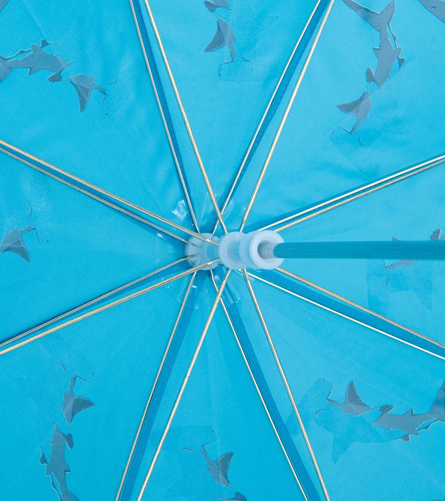 Blue umbrella canopy with shark pattern and silver spokes, close-up view