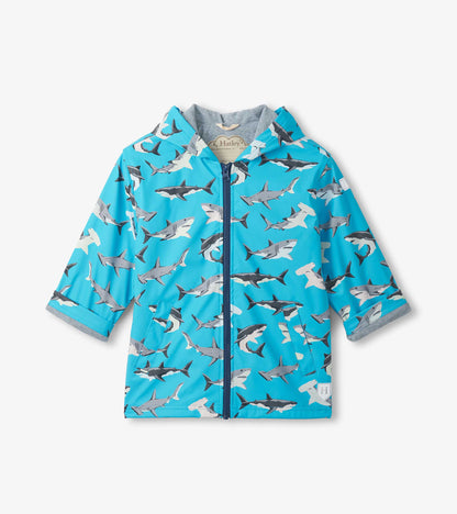 Blue hooded zip-up rain jacket with allover shark print and gray lining, front view