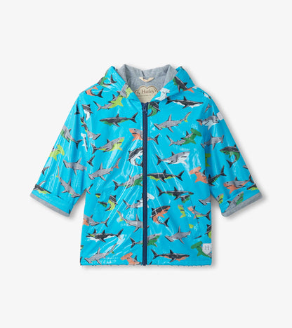 Front view of a blue zip-up rain jacket with allover shark print and gray hood lining