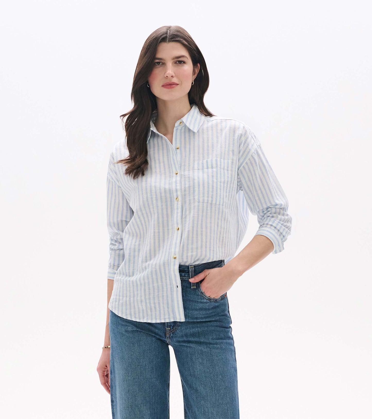 Front view of blue and white striped button-down shirt worn with jeans