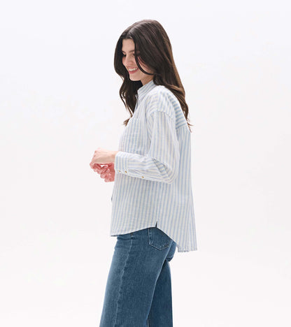Side view of blue and white striped button-down shirt with curved hem and side vent