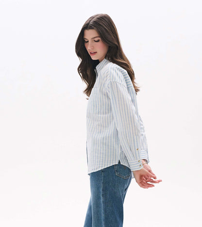 Side view of relaxed button-down shirt in pale blue and white stripes with chest pocket and curved hem