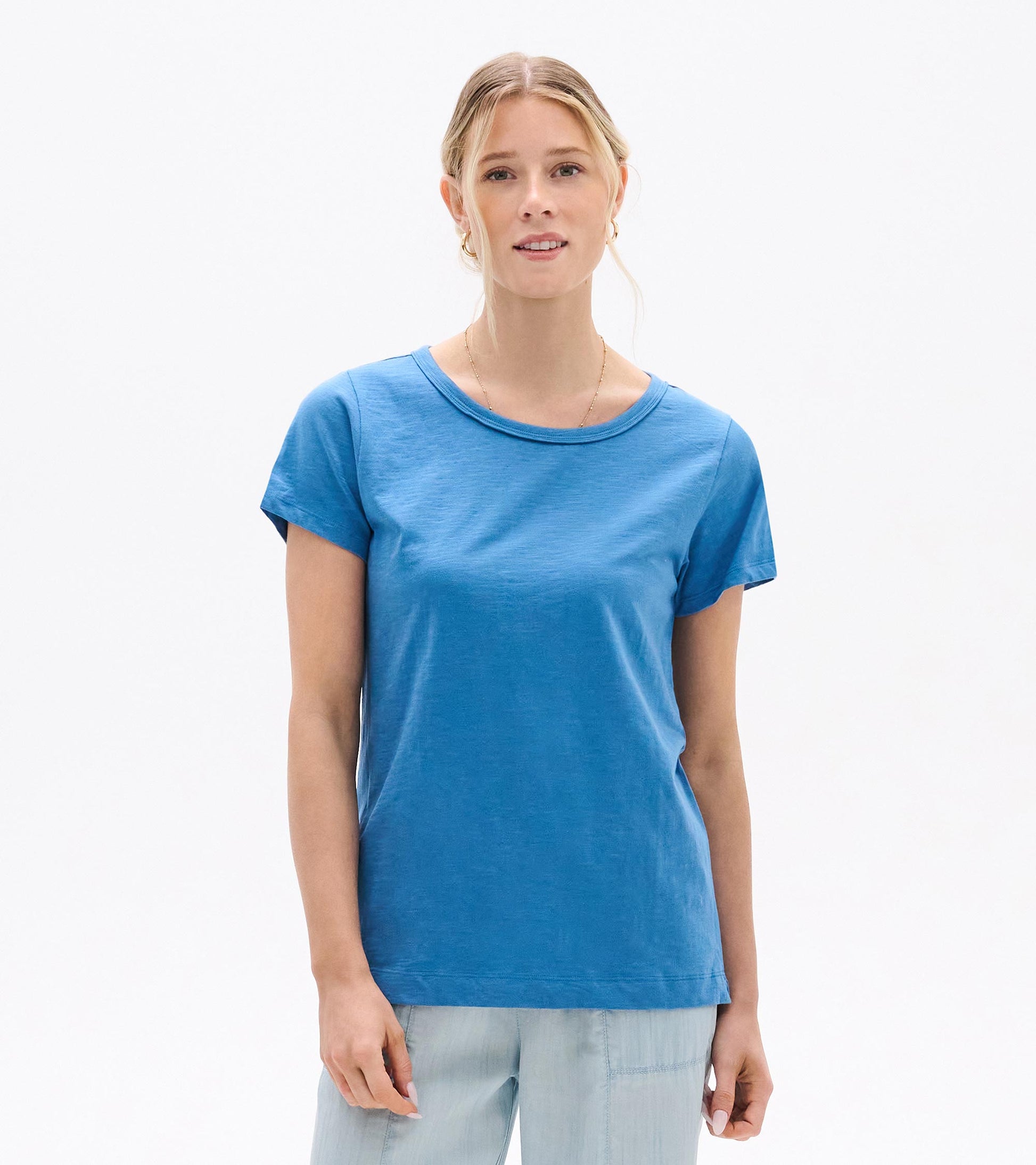 Woman wearing a blue crew neck short-sleeve tee, front view