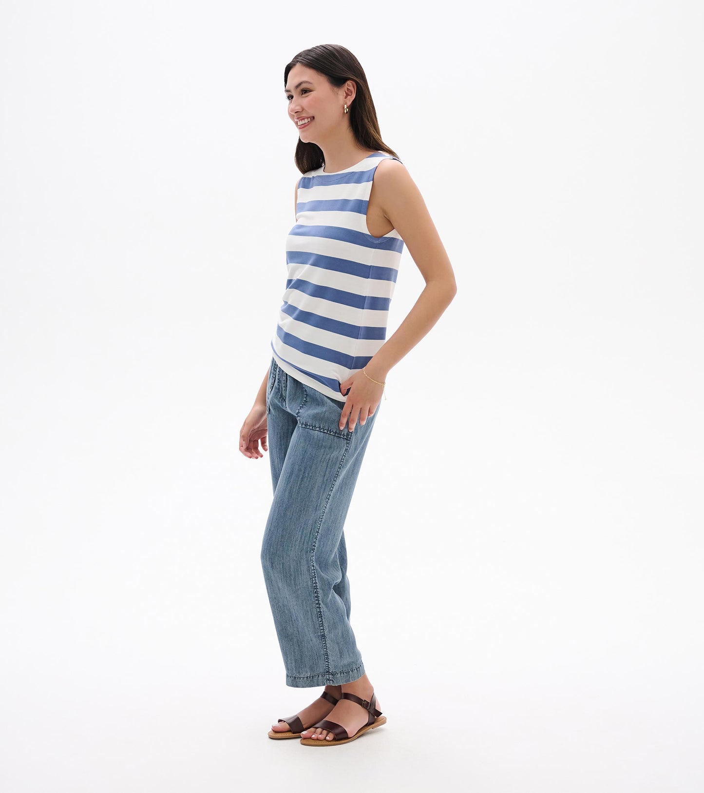 Sleeveless blue-and-white striped tank top, side view, worn with jeans and sandals