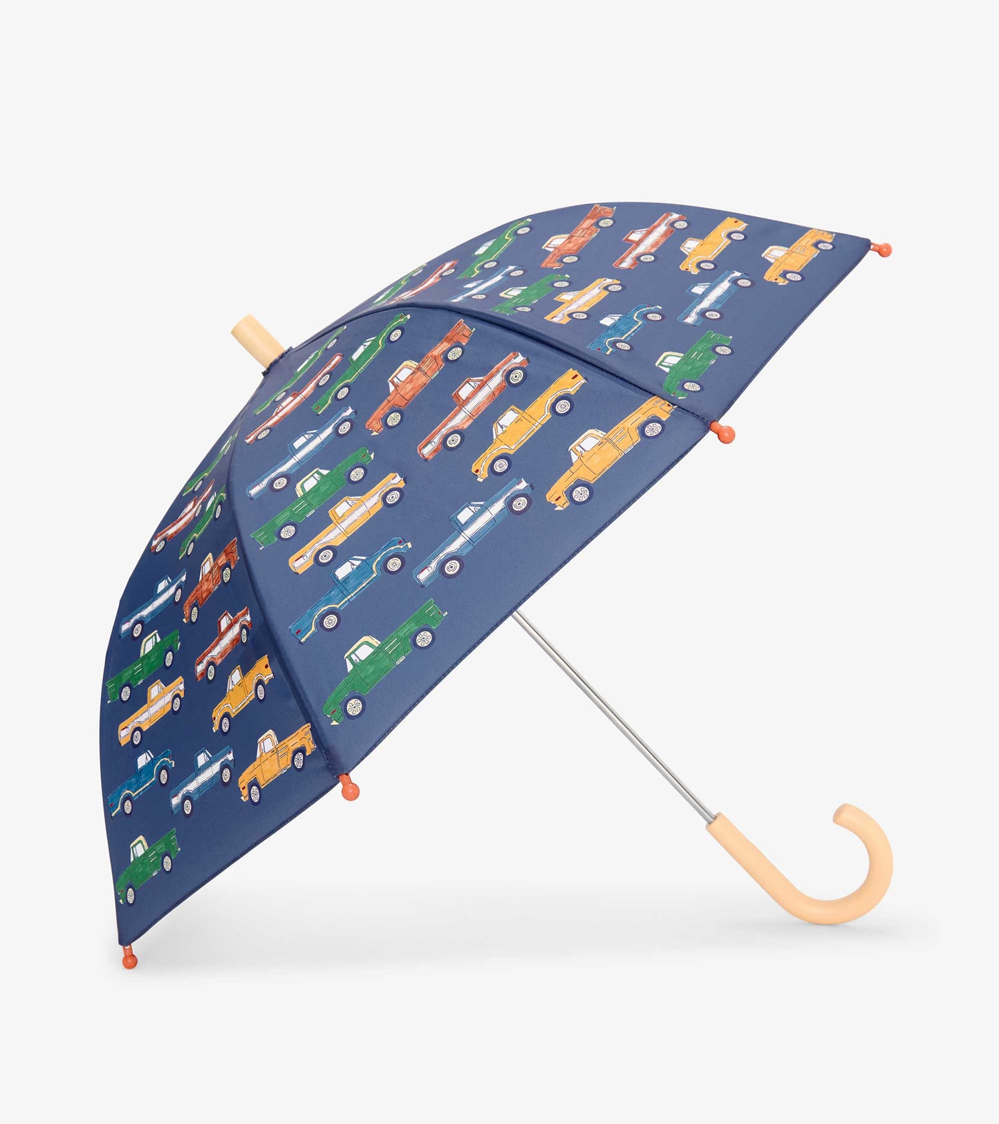 Navy kids umbrella with colorful pickup truck print and tan curved handle