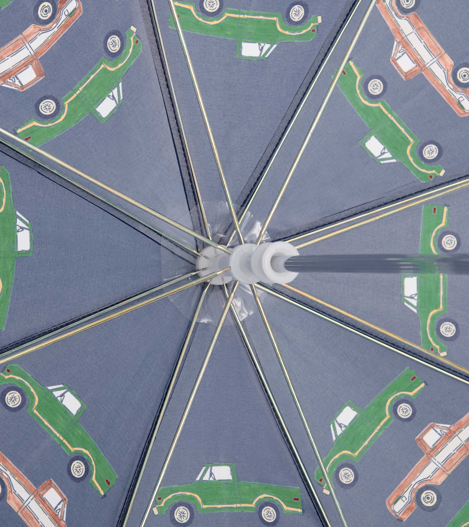 Interior view of a gray kids umbrella with green and orange truck print and metal spokes