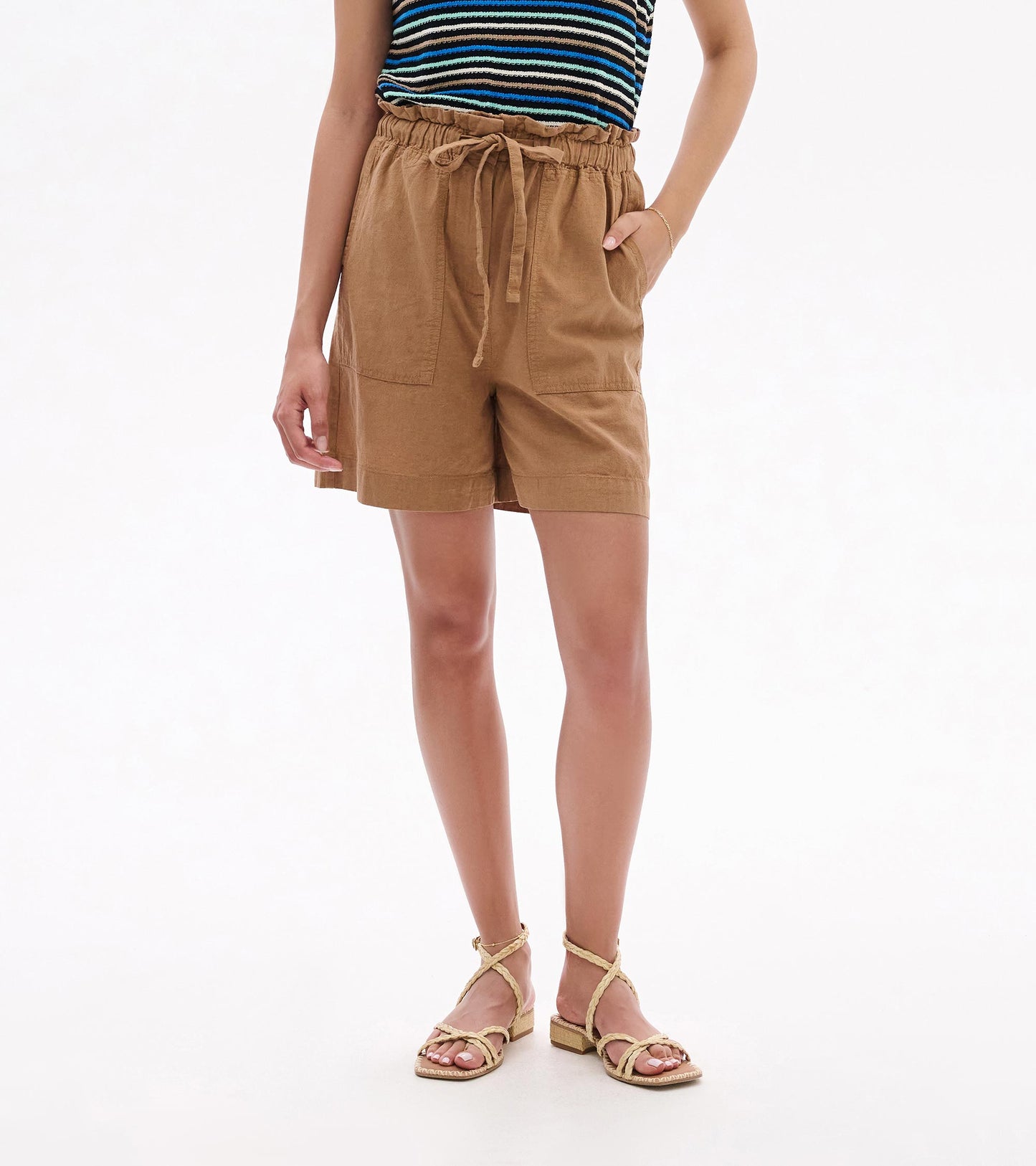 Tan drawstring shorts with elastic waist and front pockets, shown on a model front view.