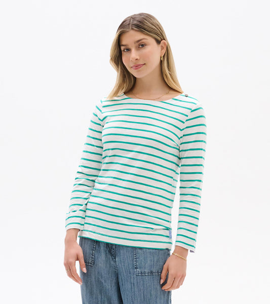 Woman wearing white long-sleeve top with teal horizontal stripes and boat neckline, front view