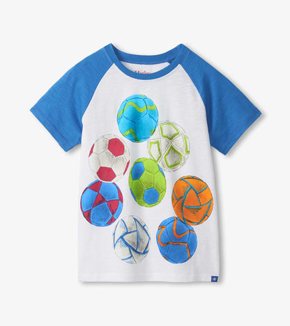 White raglan T-shirt with blue sleeves and colorful soccer ball print, front view