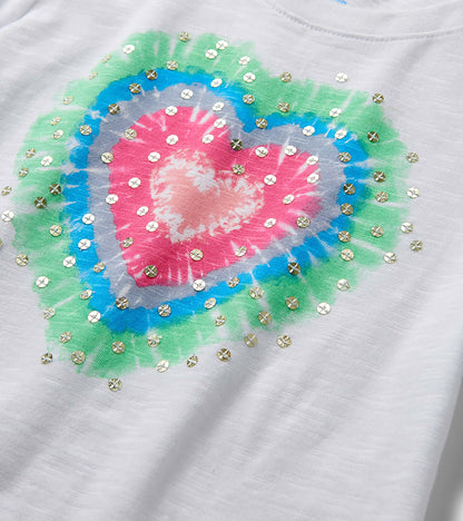 White girls' T-shirt with multicolor heart burst graphic and gold sequins, front view close-up
