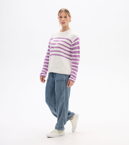 Angled front view of ivory striped sweater with lavender bands across the chest and sleeves