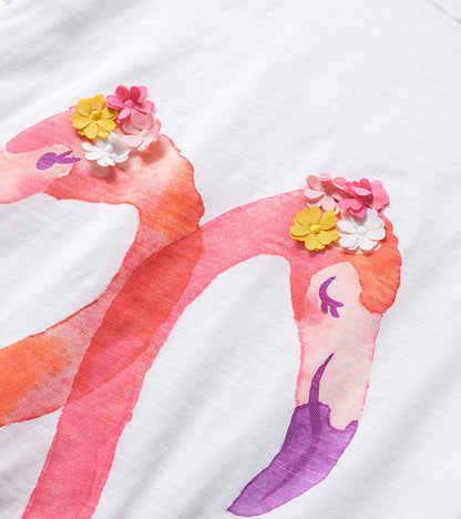 White girls' graphic tee with pink flamingo print and colorful flower appliqués