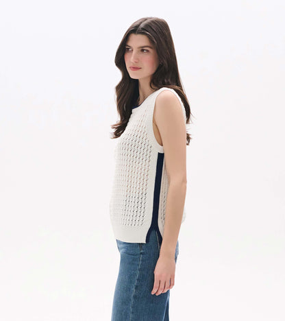 White sleeveless knit tank with open mesh texture and side slits, shown on a model in side view.