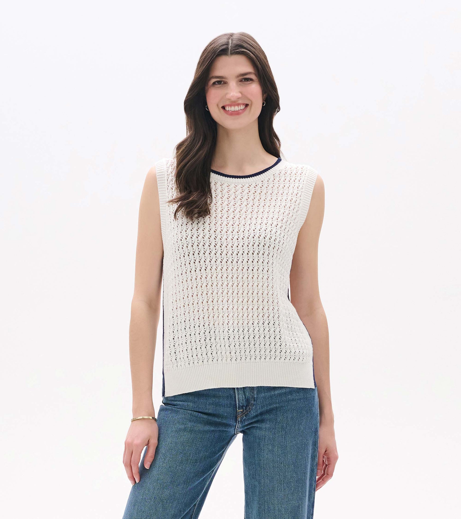 White sleeveless knit tank top with openwork texture, ribbed trim, and navy contrast neckline, front view on model.