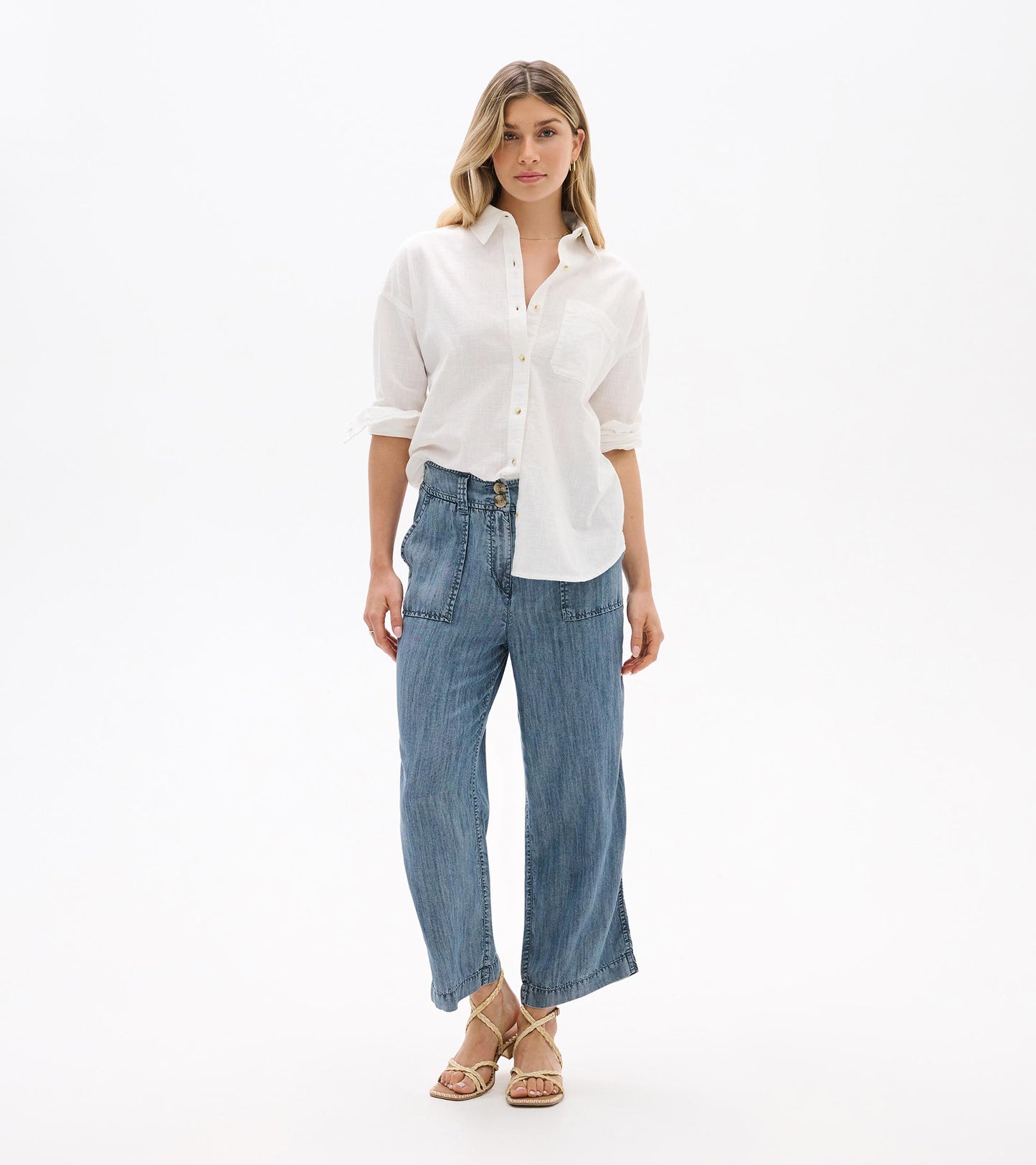 Model wearing white relaxed button-down shirt with chest pocket, front view