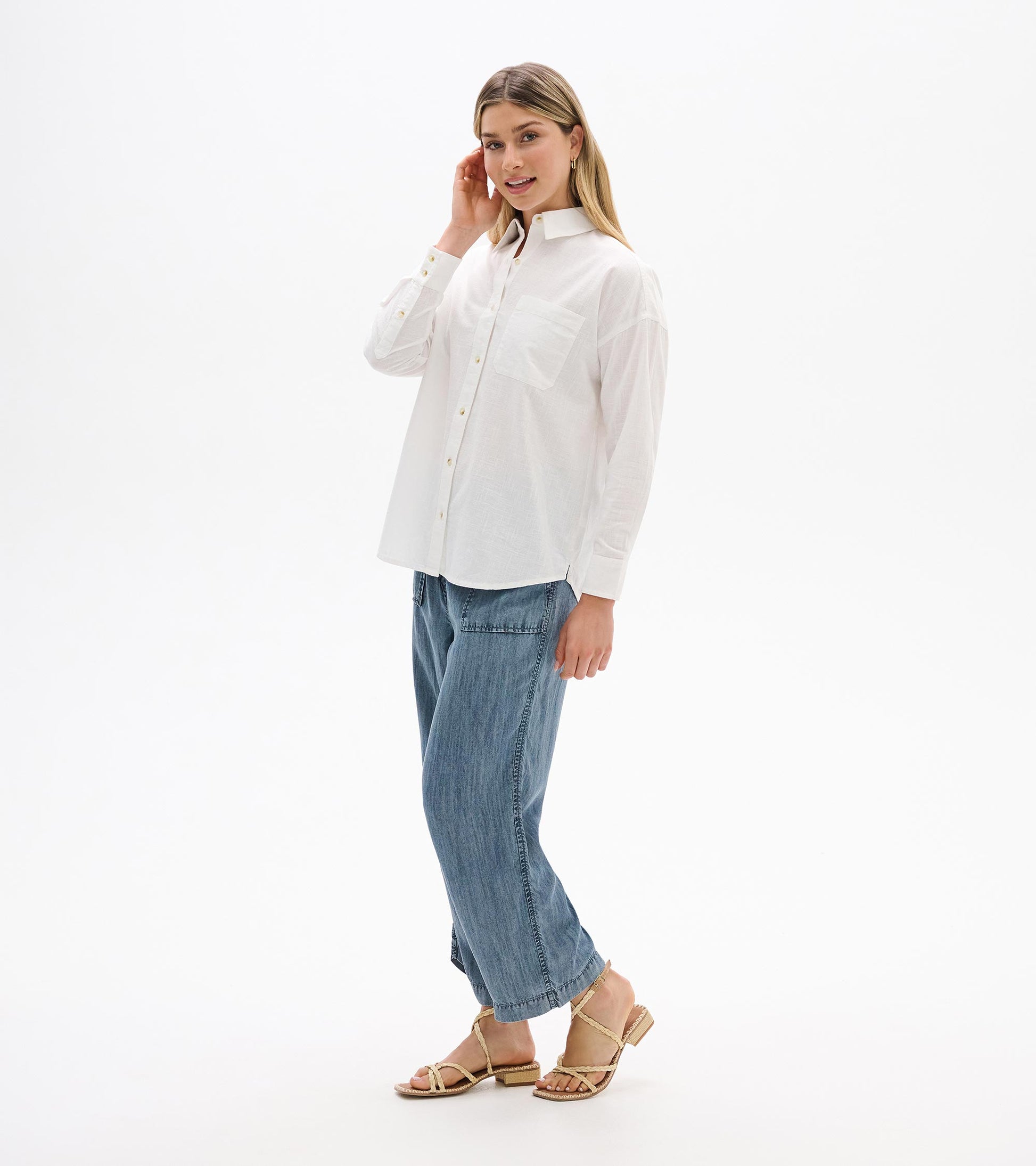 White relaxed button-down shirt on model, side front view with chest pocket