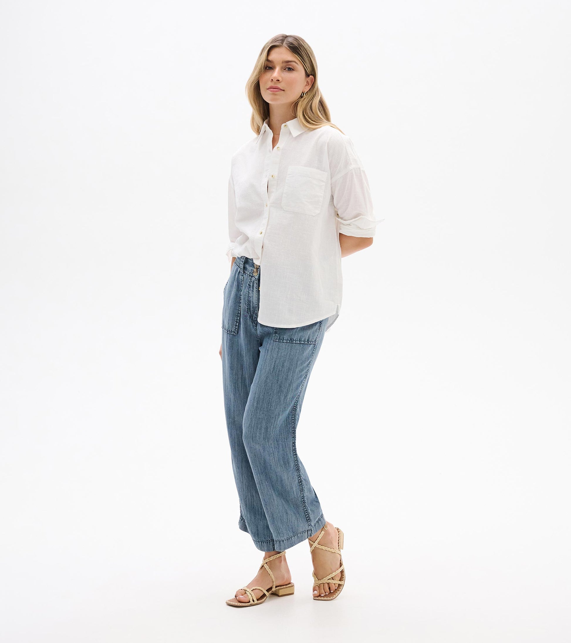 White relaxed button-down shirt with chest pocket and rolled sleeves, shown on model from the front