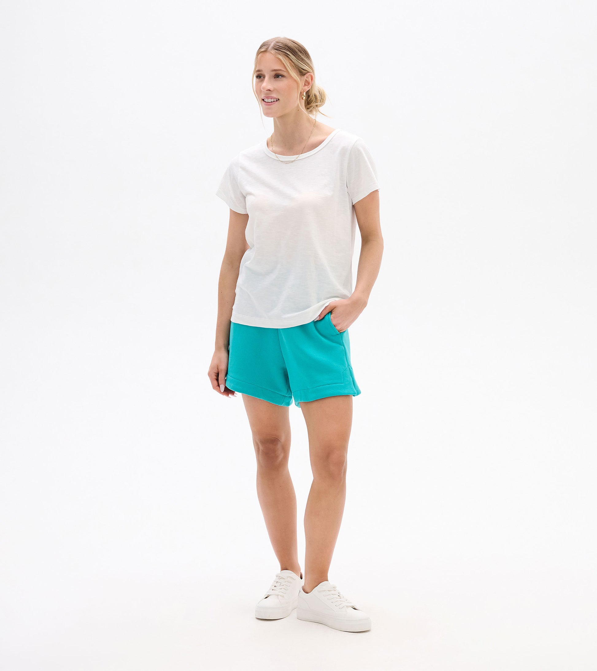 Woman wearing a white short-sleeve crew neck tee with a relaxed fit, shown front view.