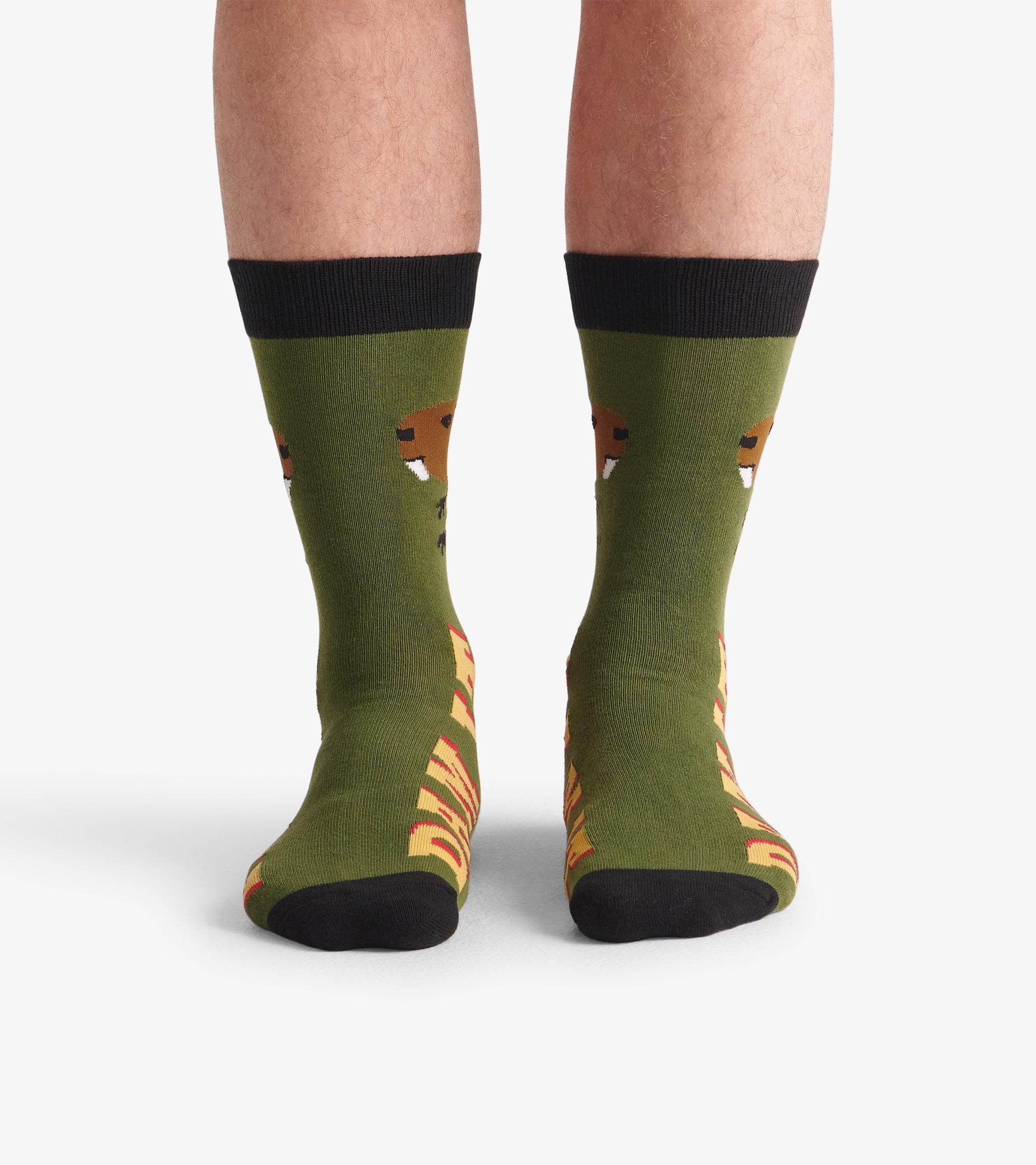Green crew socks featuring a beaver design and "DAM IT" text, with black cuffs and toe. One size fits most.