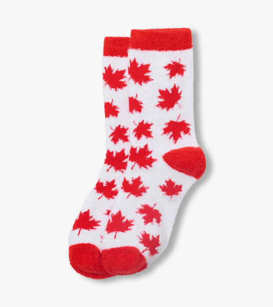 White fuzzy socks with red maple leaf pattern and red heel, toe, and cuff