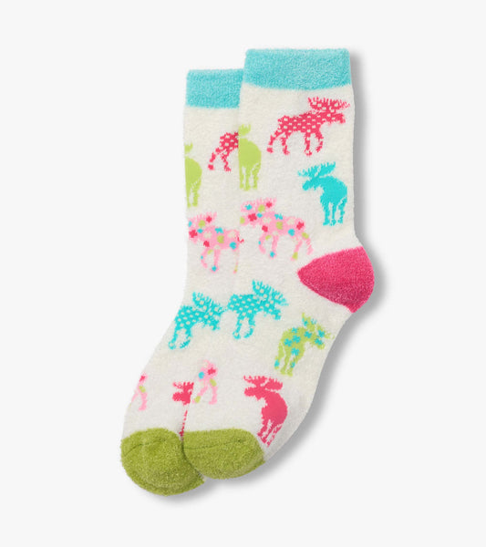 White fuzzy socks with colorful moose pattern, turquoise cuffs, green heels and toes, folded pair
