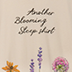 View Women's Another Blooming Sleepshirt - Floral illustration with the words "mother blooming like her" in black script, surrounded by orange, purple, and pink fl