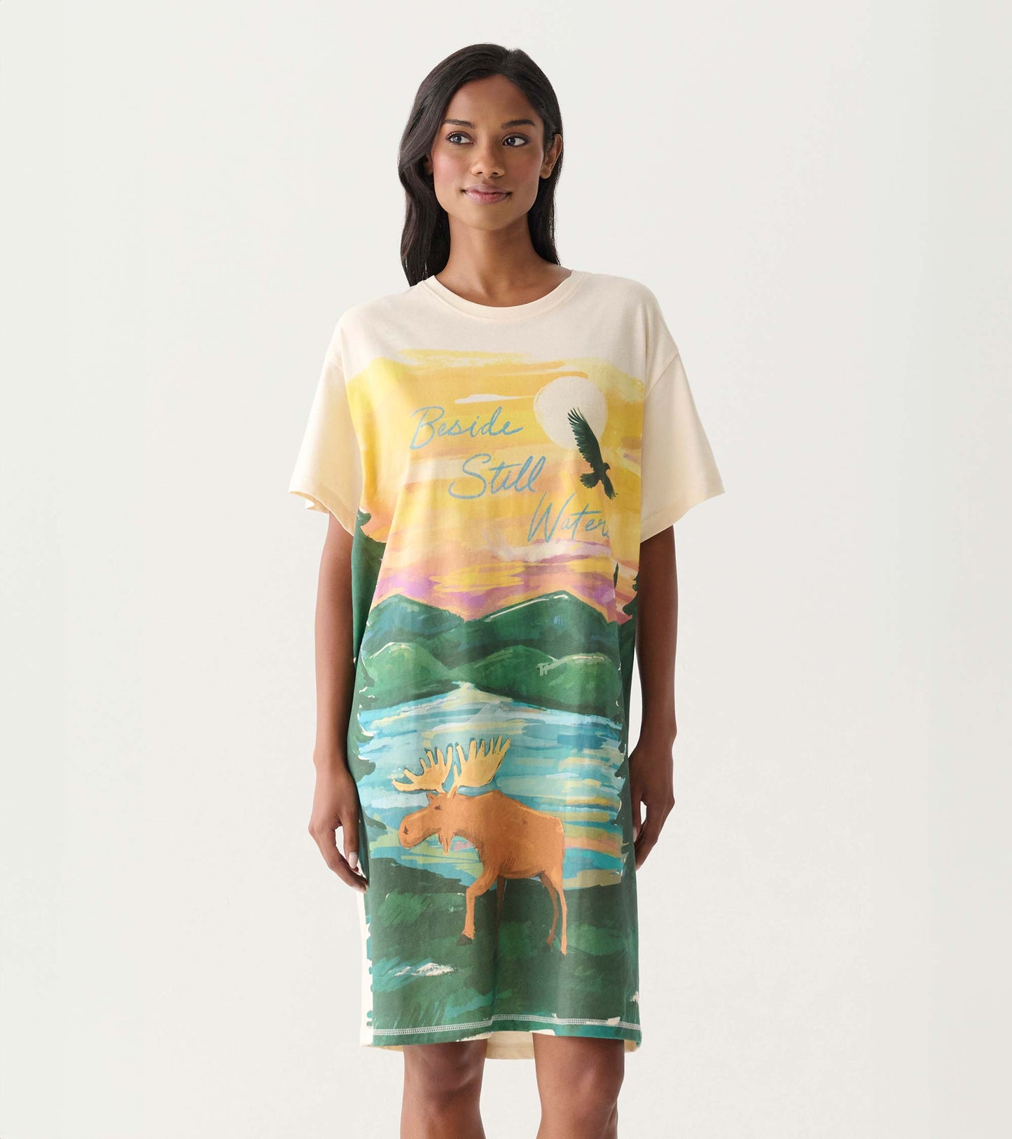 Cream short-sleeve sleepshirt with colorful sunset, lake, moose, and bird graphic print, front view