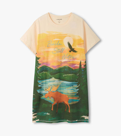 Front view of a cream sleepshirt with sunset landscape print, moose, trees, and lake scene.