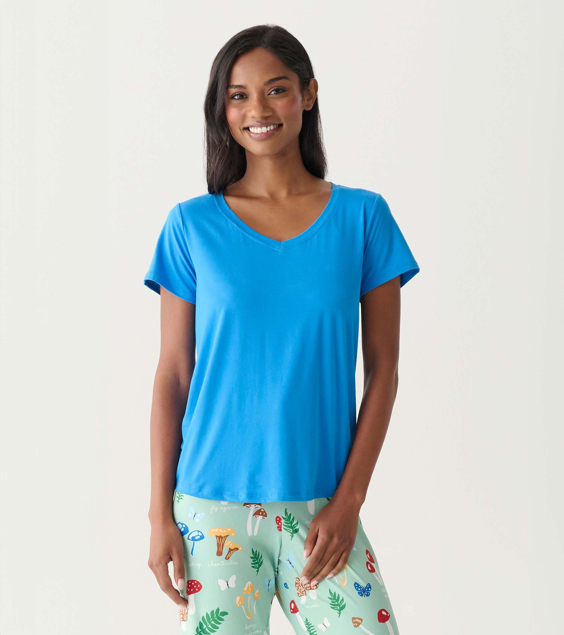 Woman wearing a bright blue V-neck T-shirt with short sleeves, front view