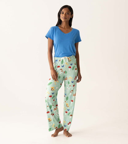 Woman wearing a blue V-neck T-shirt and mint green mushroom-print pajama pants, front view