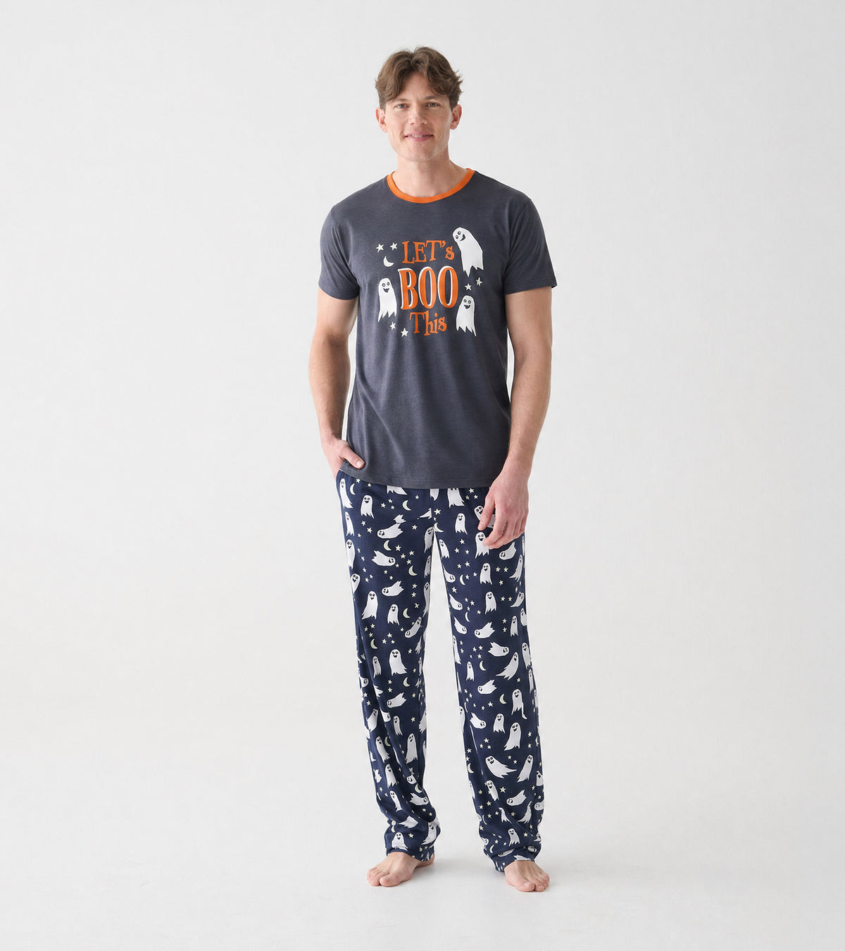 Front view of model wearing charcoal ghost graphic T-shirt with orange neckline