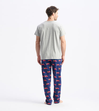 Gray short-sleeve t-shirt worn with patterned pajama pants featuring red trucks on a navy background.