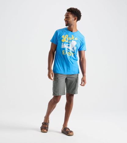 Model wearing blue Lake It Easy tee with yellow text and white chair graphic, front angled view