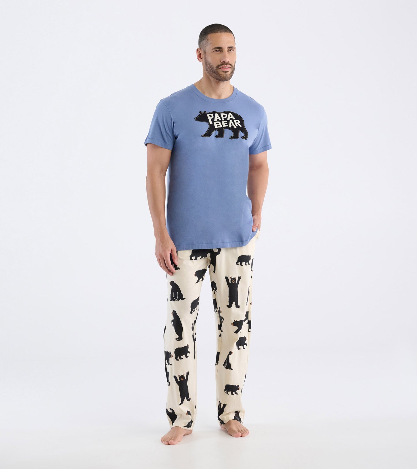 Light blue short-sleeve t-shirt featuring a black bear graphic with "PAPA BEAR" text, paired with bear-patterned pants.