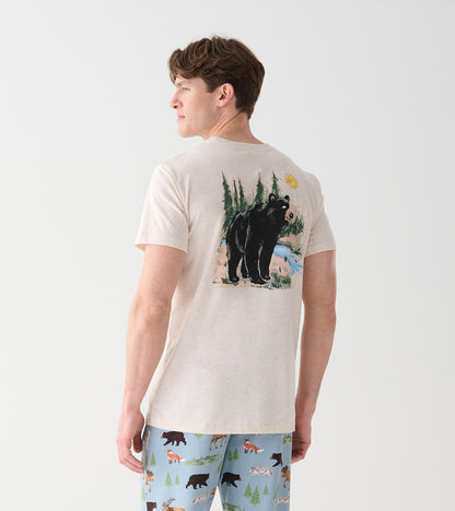 Back view of oatmeal crew neck T-shirt with black bear, trees, blue stream and yellow sun graphic