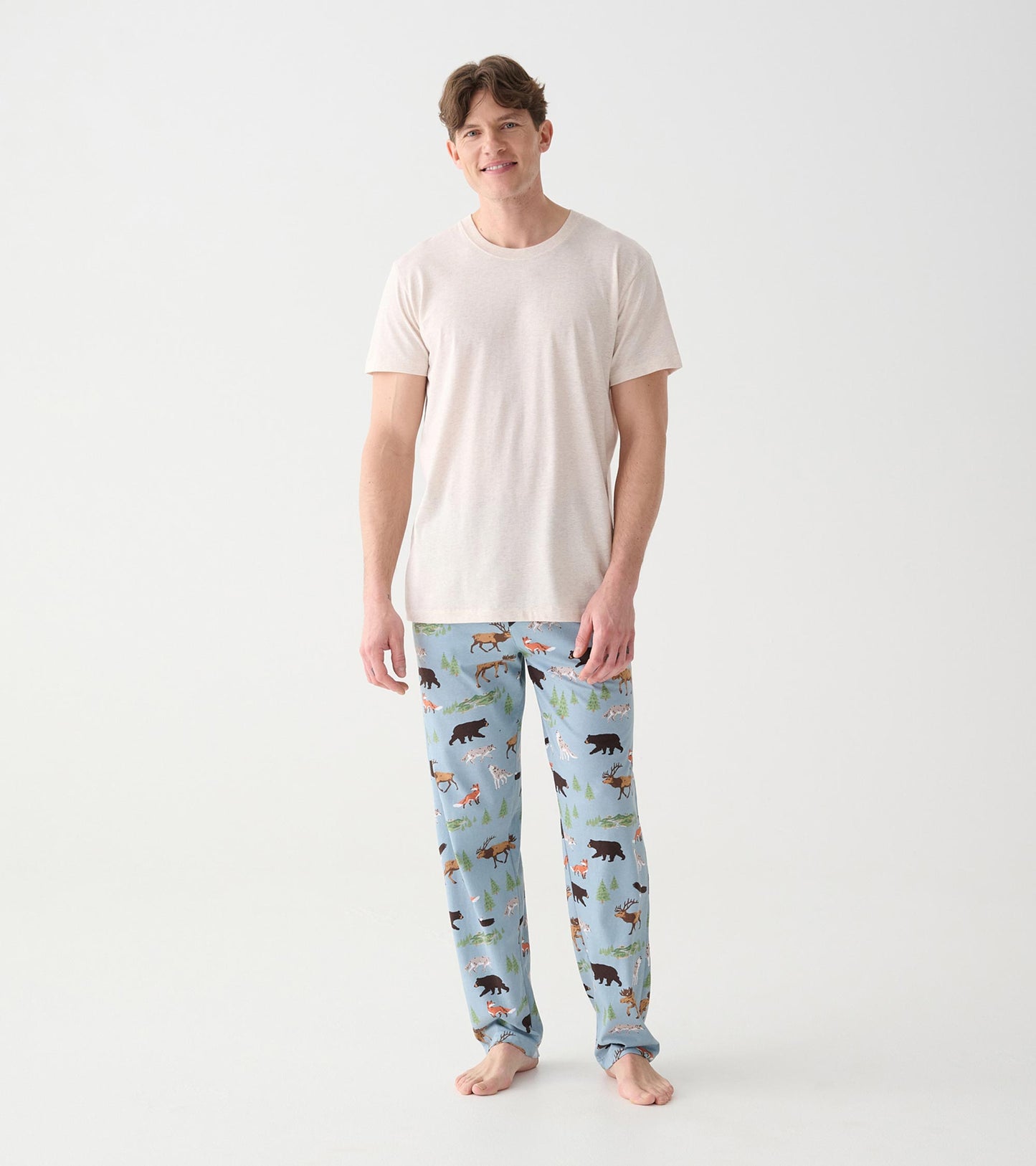 Full front view of heathered oatmeal short sleeve crew neck T-shirt worn with blue wildlife print pants