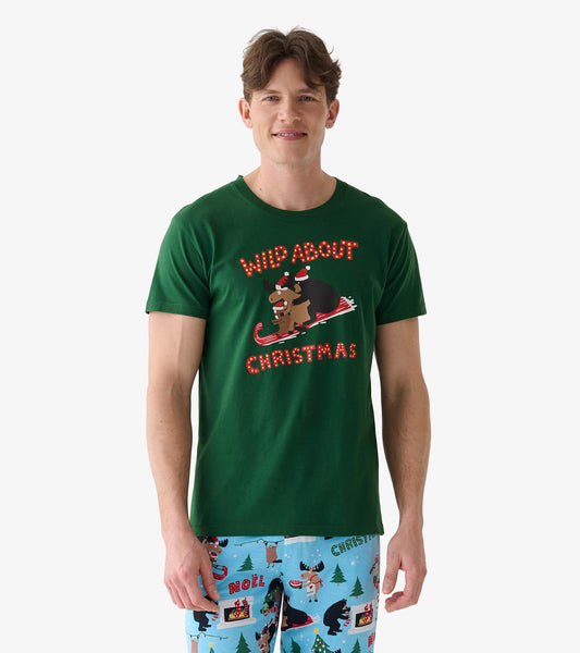 Front view of green men's Christmas T-shirt with bear and moose in Santa hats sledding on a candy cane