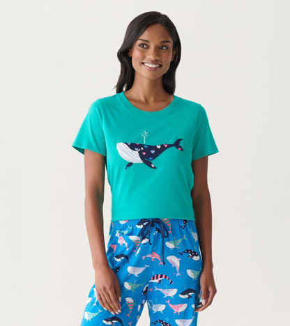 Teal short-sleeve pajama T-shirt with a whale graphic on the front, worn with blue whale-print pajama pants.