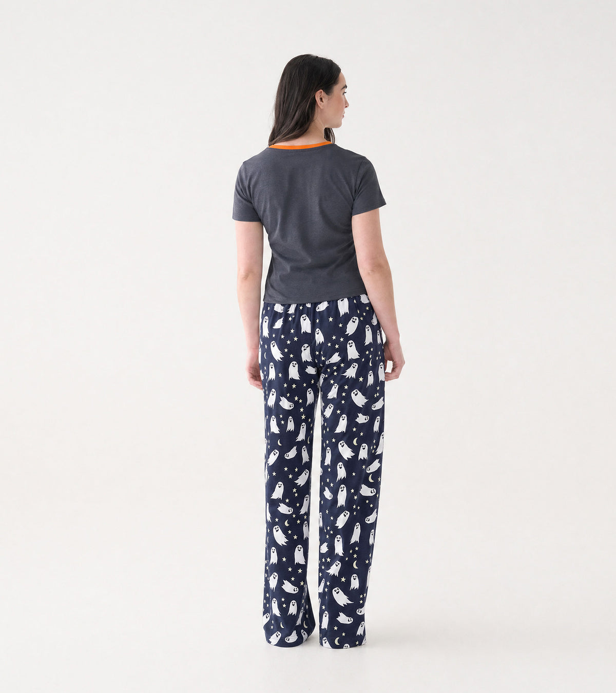 Back view of dark gray short sleeve pajama T-shirt with orange collar, worn with navy ghost print pants
