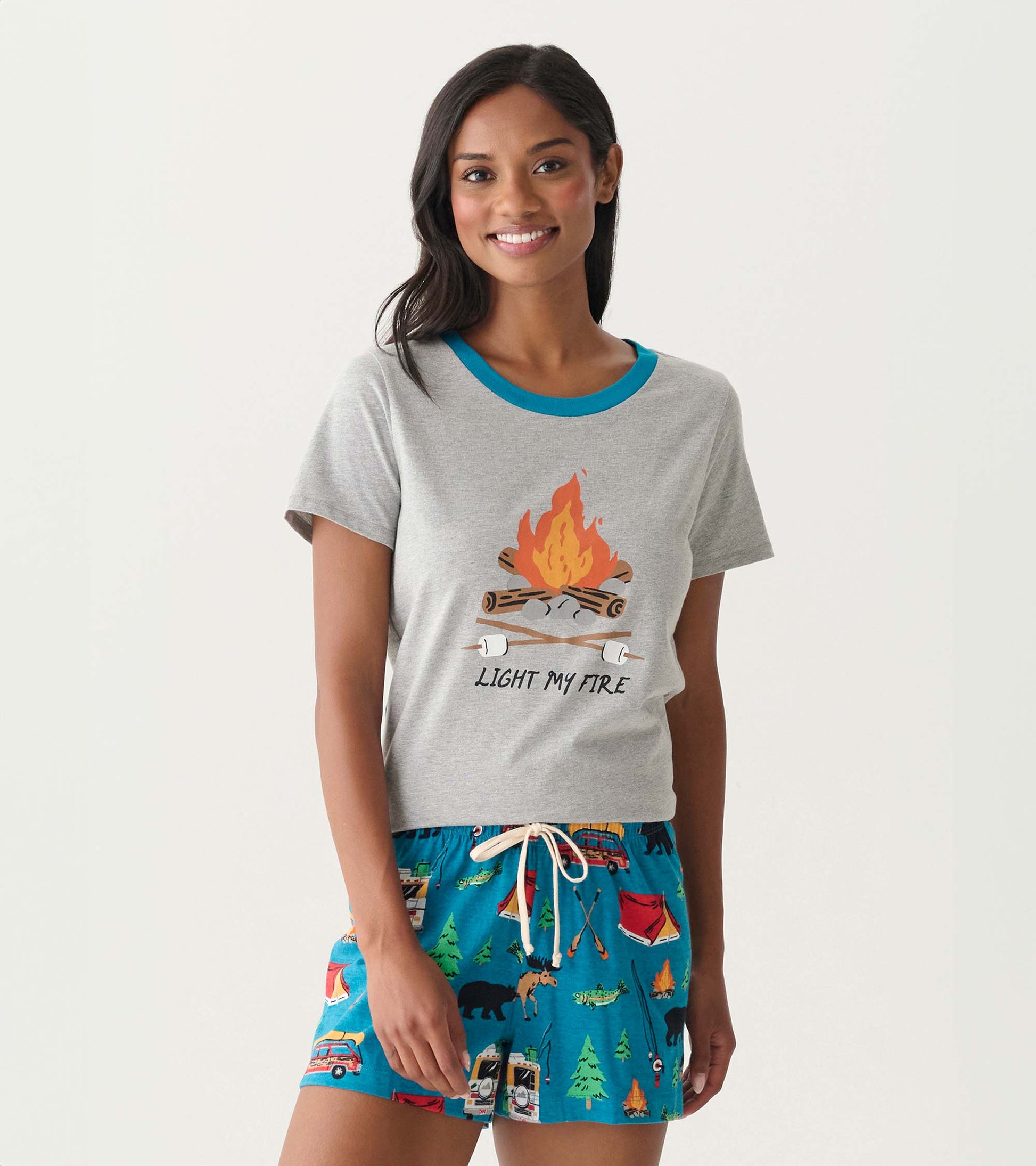 Front view of gray short-sleeve pajama top with blue trim and campfire graphic, paired with blue camping-print shorts