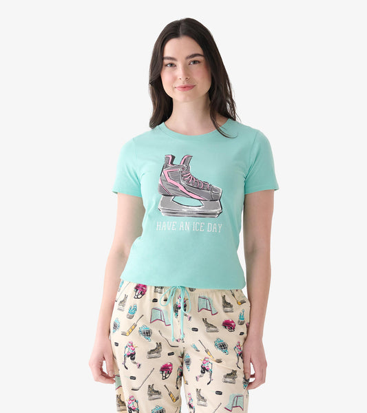 Model wearing mint pajama T-shirt with skate graphic and "Have an Ice Day" text, paired with hockey print pants