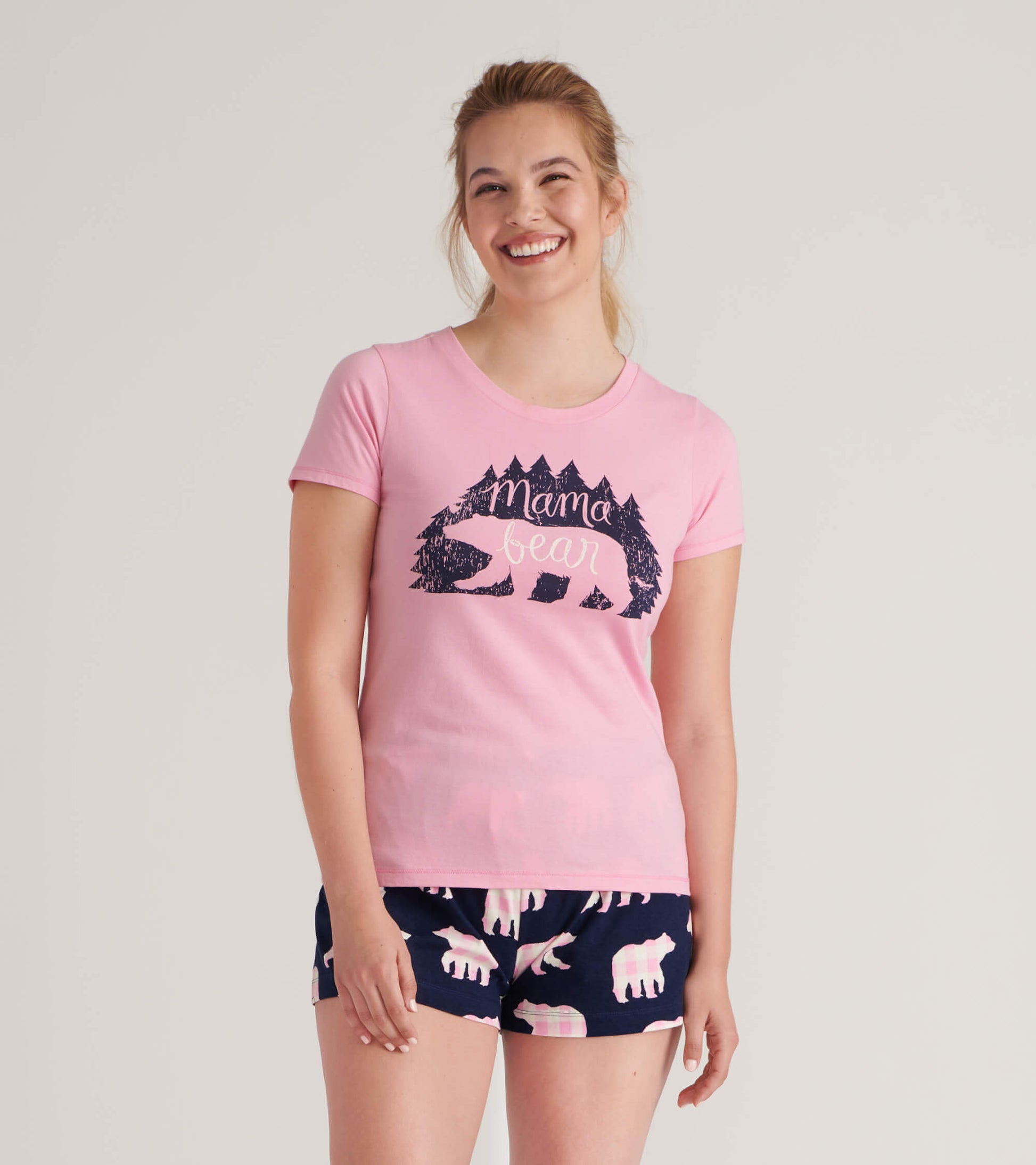 Pink women's pajama t-shirt featuring a "Mama Bear" graphic with a bear and trees design.