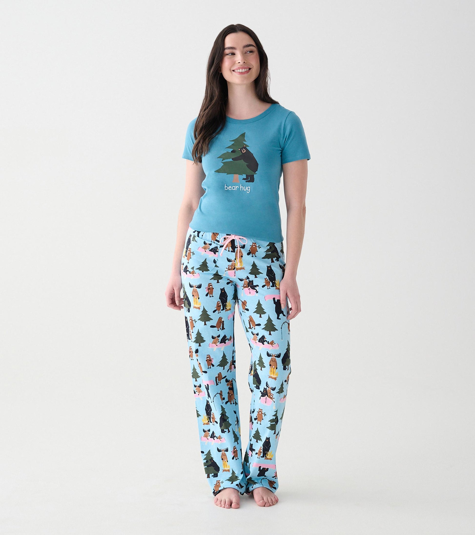 Angled front view of blue women's pajama T-shirt with bear hugging a tree graphic