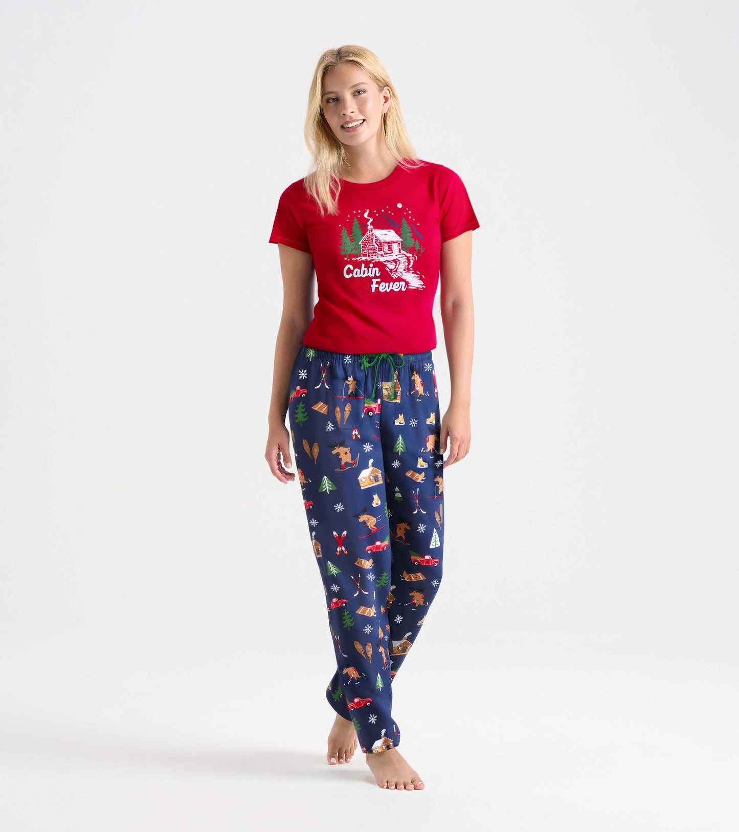 Red short-sleeve pajama t-shirt with "Cabin Fever" graphic, paired with navy pajama pants featuring a winter-themed print.