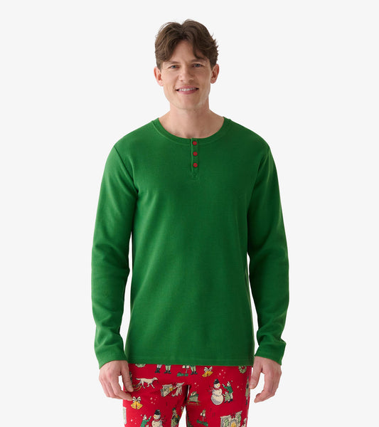 Front view of men's forest green waffle henley with long sleeves and red buttons, worn with red holiday print pants